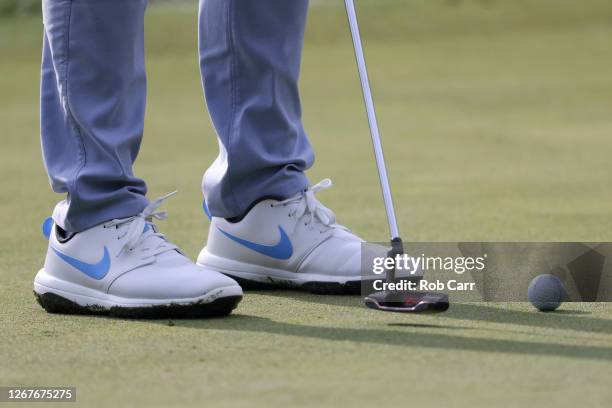 Detailed view of shoes and a golf ball are seen as Rory McIlroy of Northern Ireland putts on the first hole during the third round of The Northern...