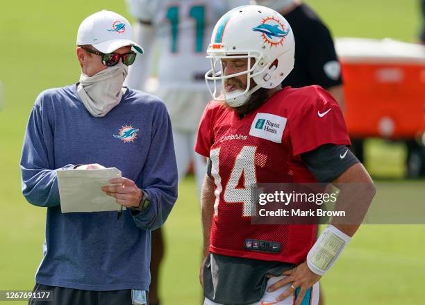 Quaterbacks coach Robby Brown of the Miami Dolphins goes over a play with Ryan Fitzpatrick of the Miami Dolphins during training camp at Baptist...