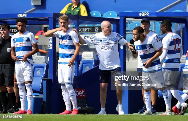 Mark Warburton, Manager of Queens Park Rangers speaks to his player before they are subbed on during the Pre-Season Friendly between Queens Park...