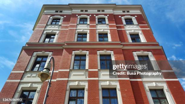 view from below of facade of isolated pre-war residential building in the district of prenzlauer berg, berlin, germany - prenzlauer berg stock pictures, royalty-free photos & images