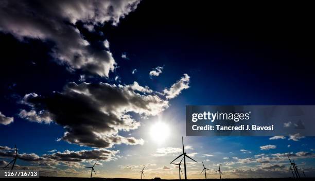 wind turbines against rural background - bavosi in cambridgeshire stock pictures, royalty-free photos & images