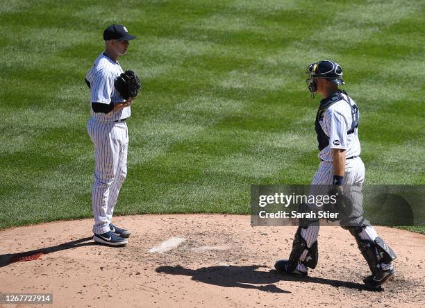 Erik Kratz of the New York Yankees meets James Paxton of the New York Yankees on the mound during the fifth inning against the Tampa Bay Rays at...