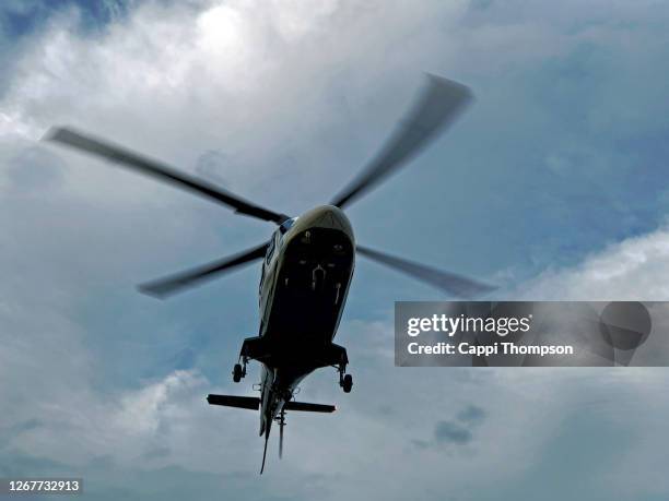 life flight helicopter hovering in the sky near auburn, maine usa - helicopter rotors stock-fotos und bilder