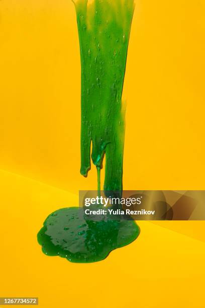 flowing blue soap on the yellow background - limoso fotografías e imágenes de stock