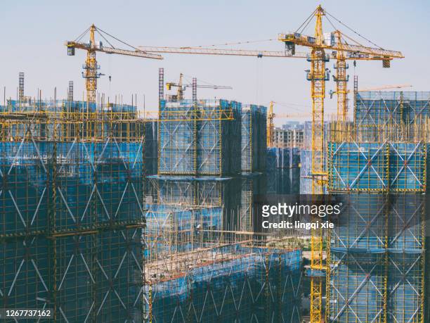 crane on a new residential area construction site - built structure stock pictures, royalty-free photos & images
