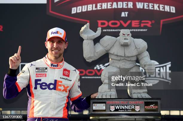 Denny Hamlin, driver of the FedEx Office Toyota, celebrates in Victory Lane after winning the NASCAR Cup Series Drydene 311 at Dover International...