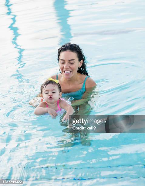 mother with baby girl in swimming pool - toddler learning stock pictures, royalty-free photos & images