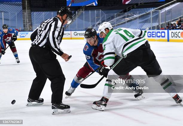 Nathan MacKinnon of the Colorado Avalanche takes an offensive zone face-off against Jamie Benn of the Dallas Stars in the first period of Game one of...