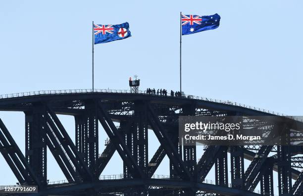 People climb the Harbour Bridge with Bridgeclimb on a sunny and windy morning on August 23, 2020 in Sydney, Australia. New South Wales remains on...