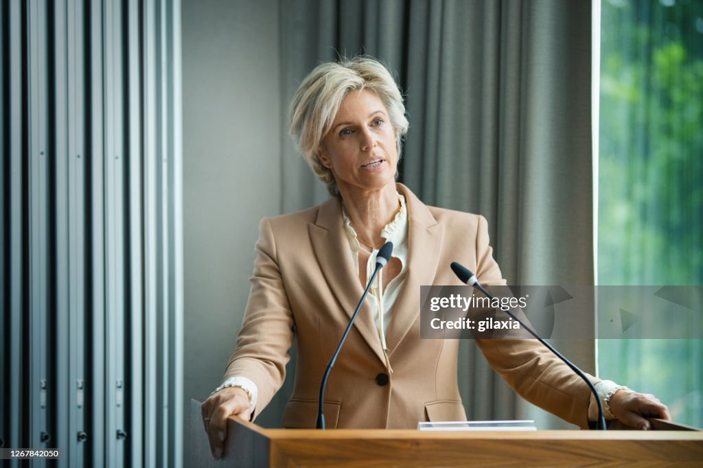 Management staff speaking at a company meeting