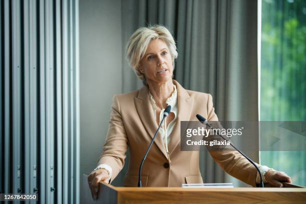 management staff speaking at a company meeting - press conference stock pictures, royalty-free photos & images