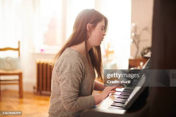 teenager at the piano - pianist stock pictures, royalty-free photos & images