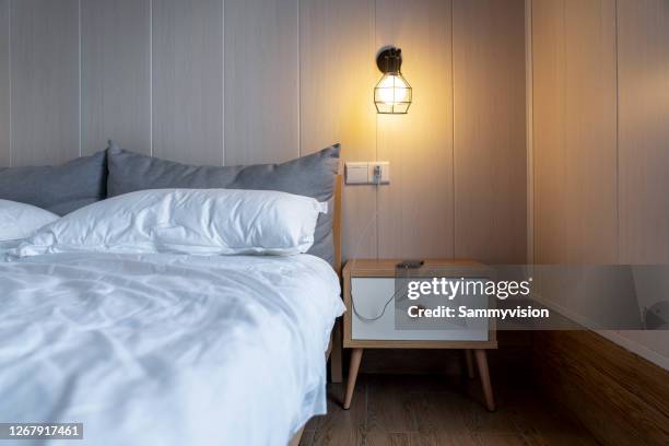 charging phone on night table - phone still life stock pictures, royalty-free photos & images