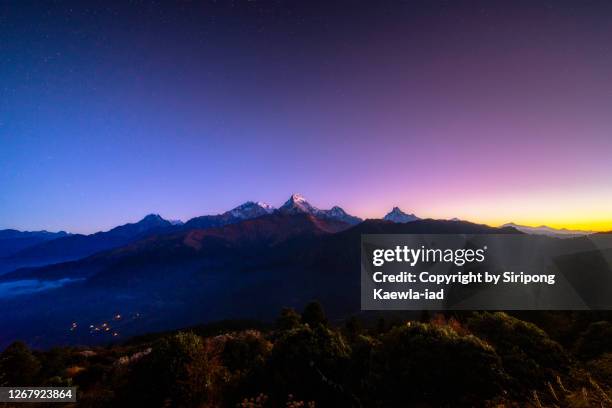 amazing view of the annapurna mountain range from poon hill viewpoint at dawn, nepal. - day and night image series stock pictures, royalty-free photos & images