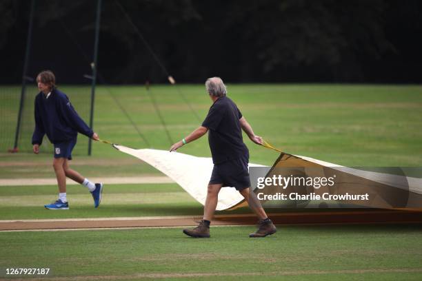Ground staff get the covers on as the rain comes down ahead of day two of the Bob Willis Trophy match between Hampshire and Essex at Arundel Cricket...