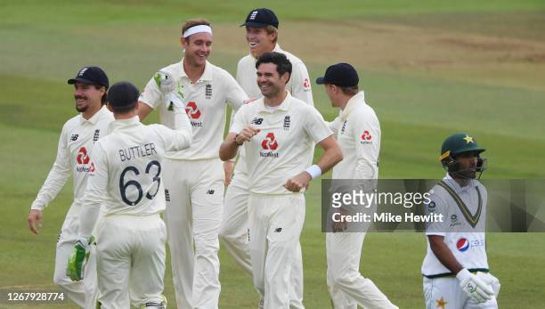 James Anderson of England celebrates with Jos Buttler and teammates after taking the wicket of Asad Shafiq of Pakistan during Day Three of the 3rd...