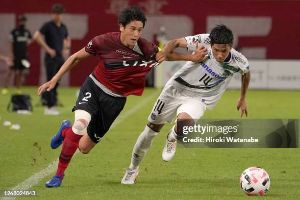 Atsuto Uchida of Kashima Antlers and Yuya Fukuda of Gamba Osaka compete for the ball during the J.League Meiji Yasuda J1 match between Kashima...