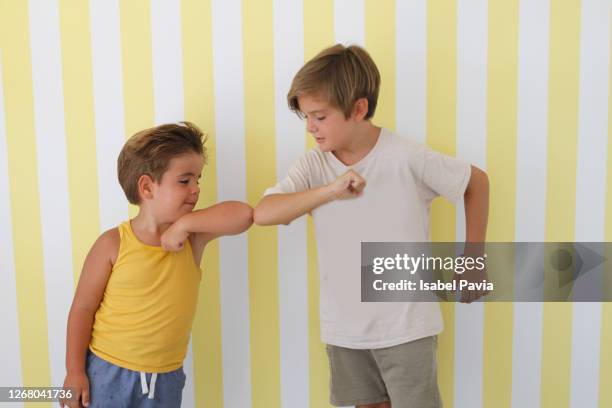 children greeting each other with an elbow bump - elbow bump stock pictures, royalty-free photos & images