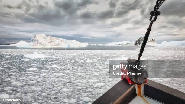 ship cruising through ilulissat icefjord drift ice and icebergs greenland - ice breaking stock pictures, royalty-free photos & images