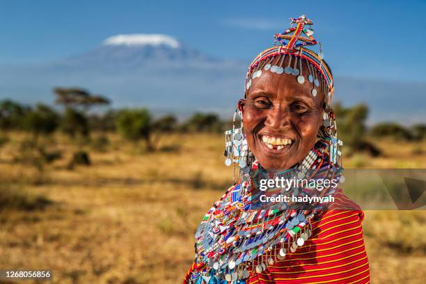 portrait of happy african woman, mount kilimanjaro on the background, kenya, east africa - masai stock pictures, royalty-free photos & images