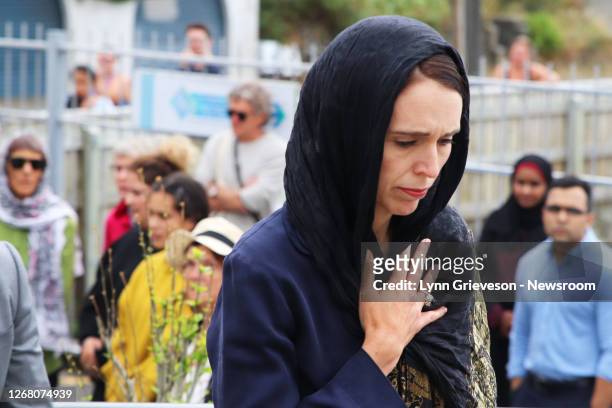 Prime Minister Jacinda Ardern, wearing hijab headscarf and watched by Muslim worshippers arrives at the Kilbirnie Mosque on March 17, 2019 in...