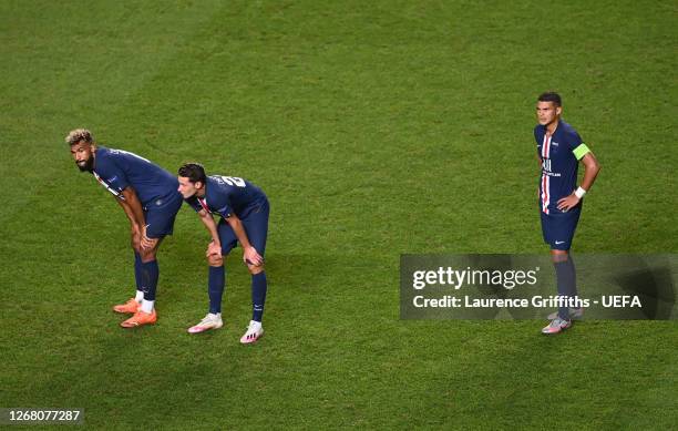 Eric Maxim Choupo-Moting, Julian Draxler, and Thiago Silva of Paris Saint-Germain look dejected following their team's defeat in the UEFA Champions...