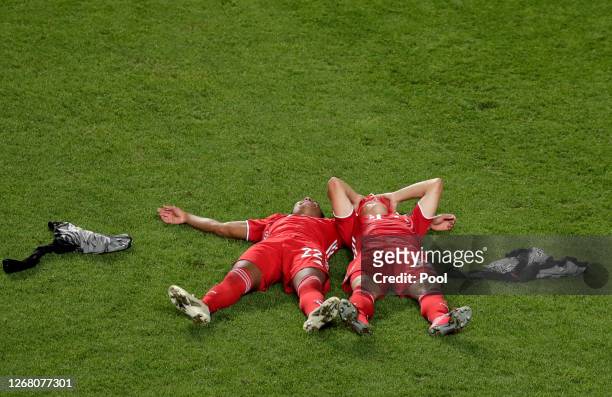 Serge Gnabry and Joshua Kimmich of FC Bayern Munich lay on the pitch in celebration following the UEFA Champions League Final match between Paris...