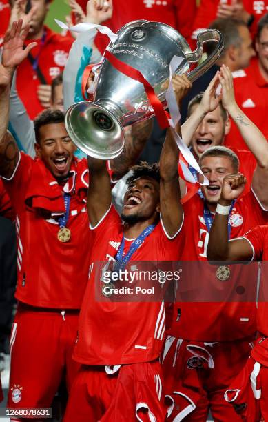 Kingsley Coman of FC Bayern Munich lifts the UEFA Champions League Trophy following his team's victory in the UEFA Champions League Final match...