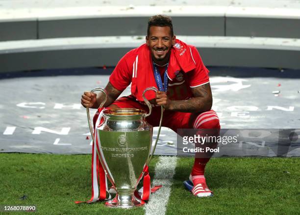 Jerome Boateng of FC Bayern Munich celebrates with the Champions League Trophy following his team's victory in the UEFA Champions League Final match...