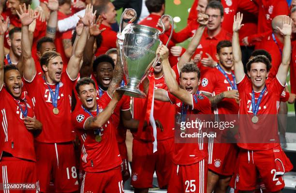 Philippe Coutinho and Thomas Mueller of FC Bayern Munich lift the UEFA Champions League Trophy following their team's victory in the UEFA Champions...