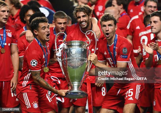 Philippe Coutinho, Michael Cuisance, Javi Martinez, and Thomas Mueller of FC Bayern Munich celebrate with the UEFA Champions League Trophy following...