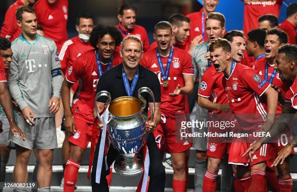 Hans-Dieter Flick, Head Coach of FC Bayern Munich celebrates with the UEFA Champions League Trophy following his team's victory in the UEFA Champions...