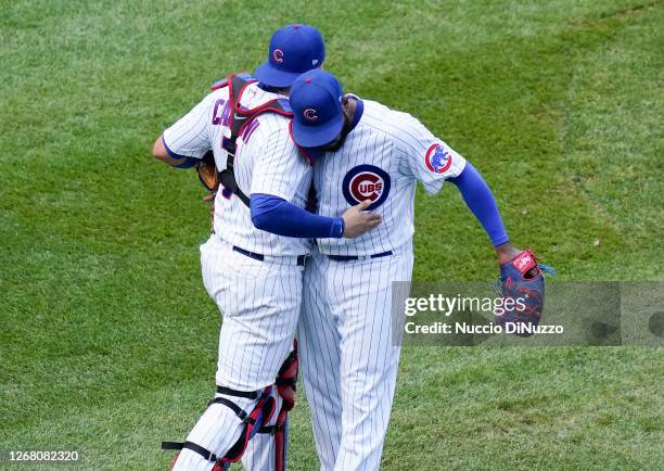 Jeremy Jeffress of the Chicago Cubs celebrates with Victor Caratini after their 2-1 win over the Chicago White Sox at Wrigley Field on August 23,...