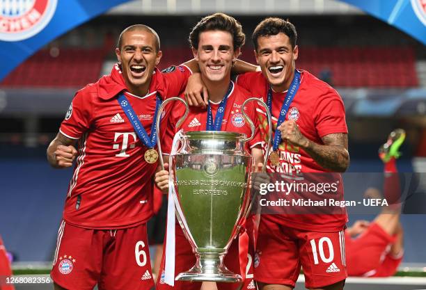 Thiago Alcantara, Alvaro Odriozola and Philippe Coutinho of FC Bayern Munich celebrate with the UEFA Champions League Trophy following their team's...