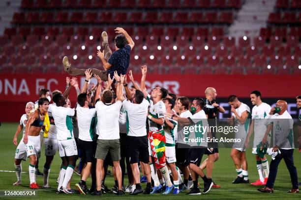 Elche CF players toss Head Coach Jose Rojo Martin 'Pacheta' after the La Liga Smartbank Playoffs match between Girona FC and Elche CF at Montilivi...