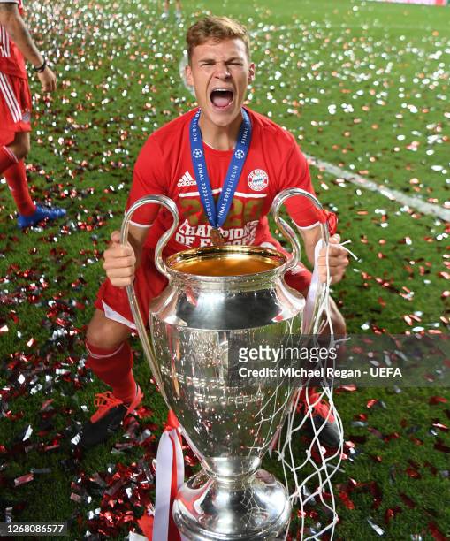 Joshua Kimmich of FC Bayern Munich celebrates with the UEFA Champions League Trophy following his team's victory in the UEFA Champions League Final...