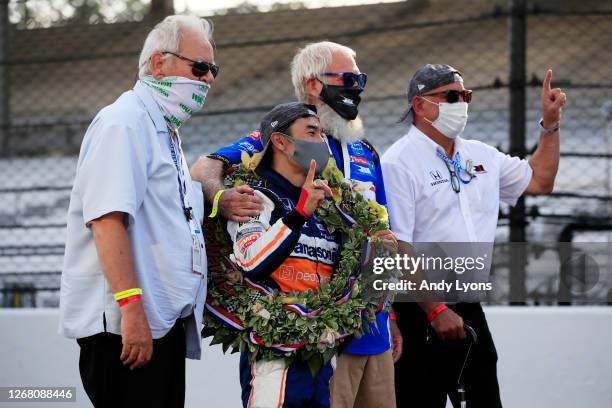 Takuma Sato, driver of the Panasonic / PeopleReady Rahal Letterman Lanigan Racing Honda, celebrates with David Letterman, Bobby Rahal, and Mike...