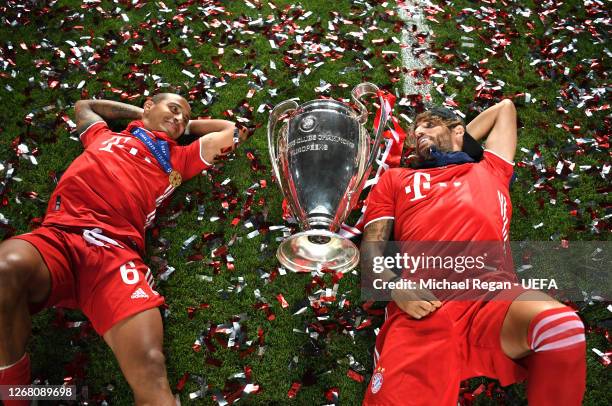 Thiago Alcantara of FC Bayern Munich and Javi Martinez of FC Bayern Munich celebrate with the UEFA Champions League Trophy following their team's...