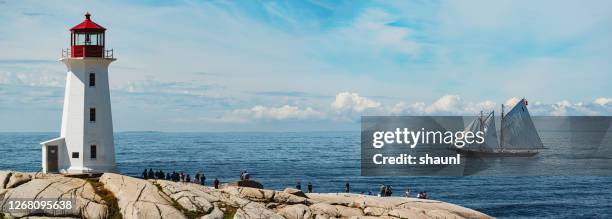 bluenose ii at peggy's cove lighthouse - peggy's cove stock pictures, royalty-free photos & images