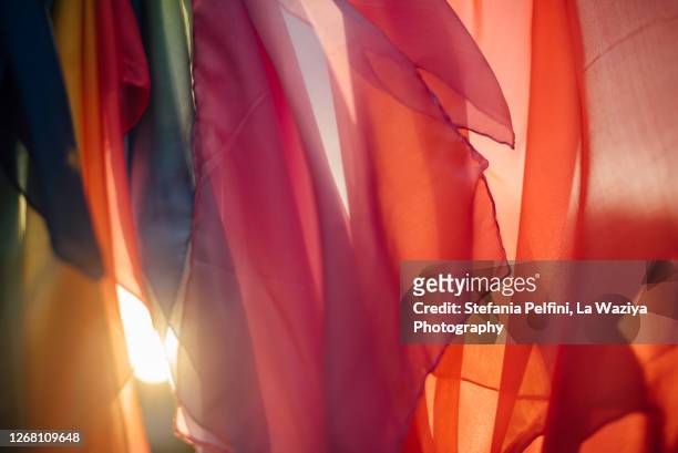 colored silks at sunset - orange silk background stock-fotos und bilder