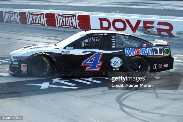 Kevin Harvick, driver of the Mobil 1 Ford, celebrates after winning the NASCAR Cup Series Drydene 311 at Dover International Speedway on August 23,...