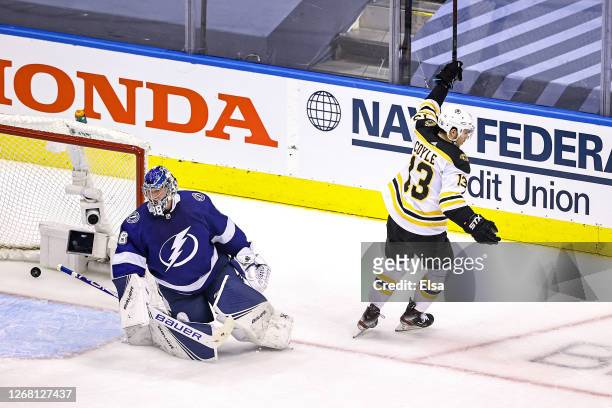 Charlie Coyle of the Boston Bruins scores a goal past Andrei Vasilevskiy of the Tampa Bay Lightning during the first period in Game One of the...