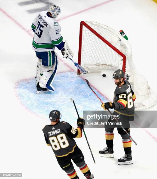 Max Pacioretty of the Vegas Golden Knights celebrates his third period goal along with Nate Schmidt against Jacob Markstrom of the Vancouver Canucks...