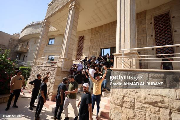 Supporters of Shiite Muslim leader Moqtada Sadr, demonstrate inside the courtyard of the Swedish embassy in Baghdad after they breached the building...