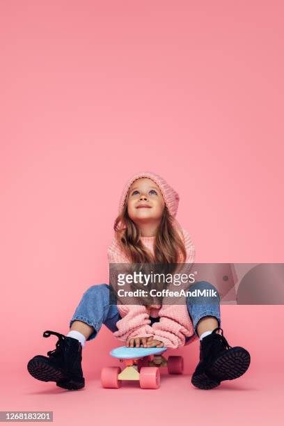 studio portrait of a cute girl with skateboard - fashion kids stock pictures, royalty-free photos & images