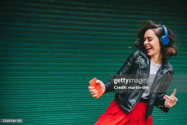 millennial girl enjoying rock music - dance music stock pictures, royalty-free photos & images