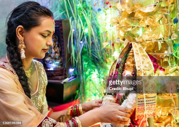happy indian young woman celebrating ganesh chaturthi festival. - ganesh chaturthi stock pictures, royalty-free photos & images