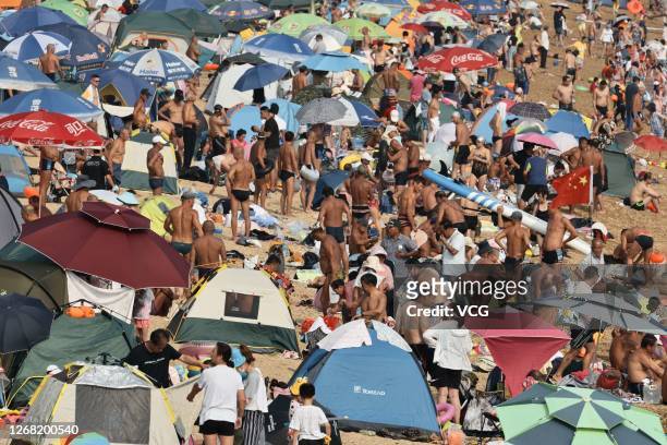 People cool off at a bathing beach on August 22, 2020 in Dalian, Liaoning Province of China.