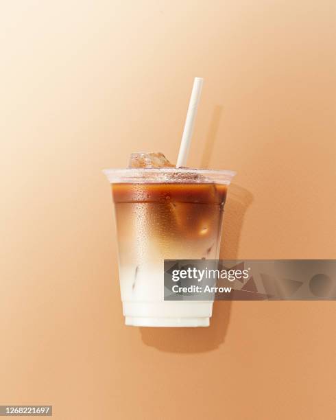 cup of cafe latte on brown background - mokka eis stock-fotos und bilder