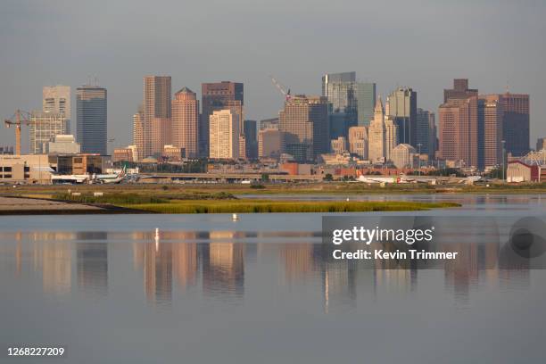 city of boston and logan international airport from across water - boston logan international airport stock pictures, royalty-free photos & images